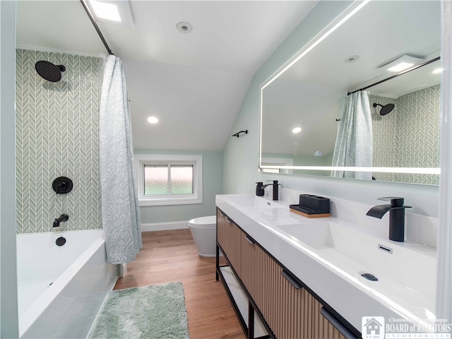 full bathroom with lofted ceiling, shower / bath combo, toilet, hardwood / wood-style floors, and vanity