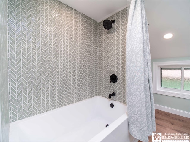 bathroom with shower / tub combo with curtain and hardwood / wood-style flooring