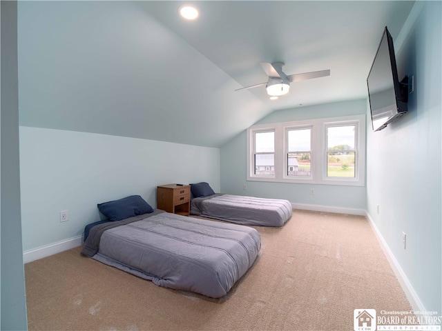 bedroom with lofted ceiling, light colored carpet, and ceiling fan