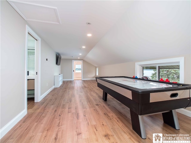 game room with light hardwood / wood-style floors, vaulted ceiling, and a wealth of natural light