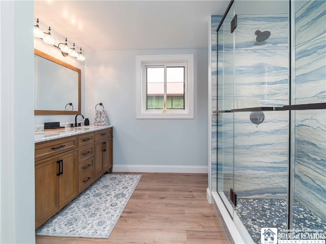 bathroom featuring vanity, a shower with shower door, and hardwood / wood-style flooring