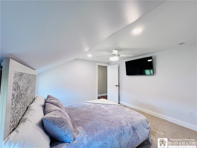 carpeted bedroom featuring ceiling fan and vaulted ceiling