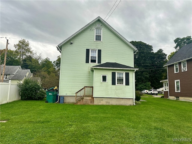 rear view of house with a lawn