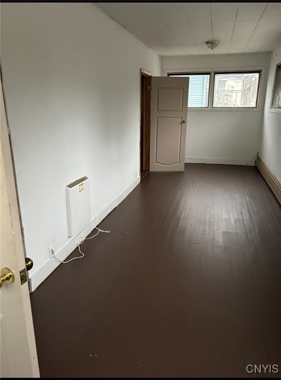 spare room featuring dark hardwood / wood-style flooring