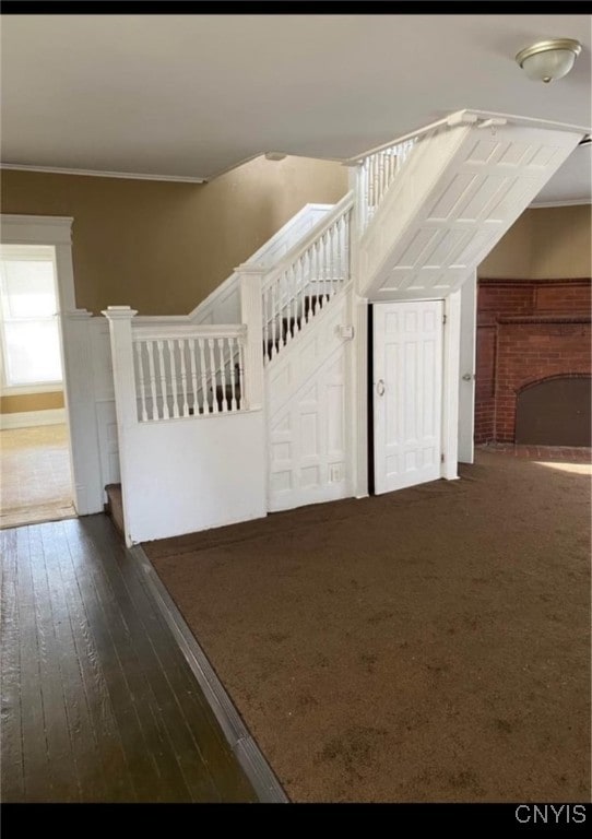 bonus room featuring a fireplace and dark hardwood / wood-style flooring