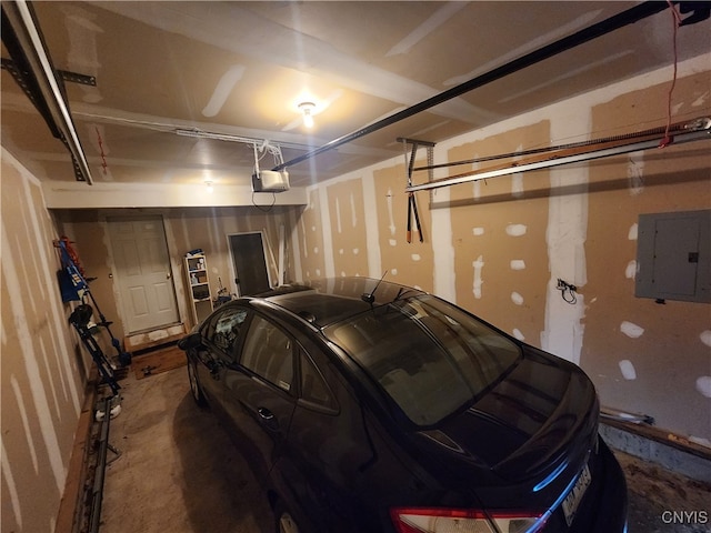 garage with a garage door opener and electric panel