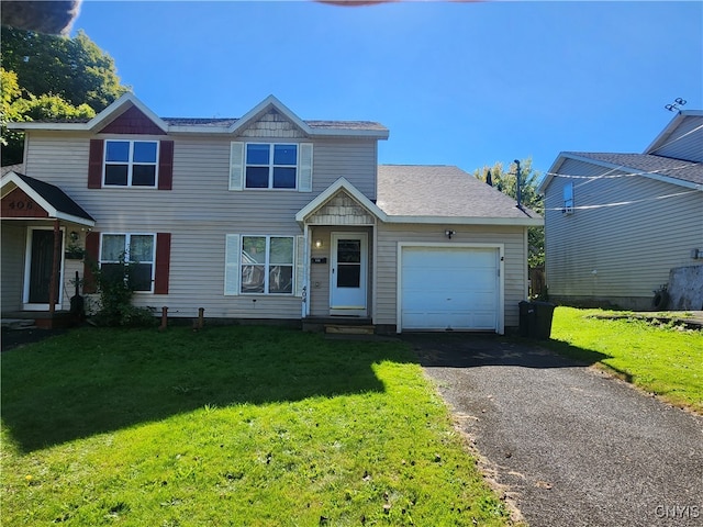 view of front of property featuring a garage and a front lawn