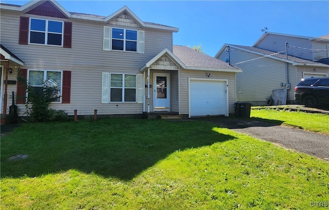 view of front of house with a garage and a front lawn