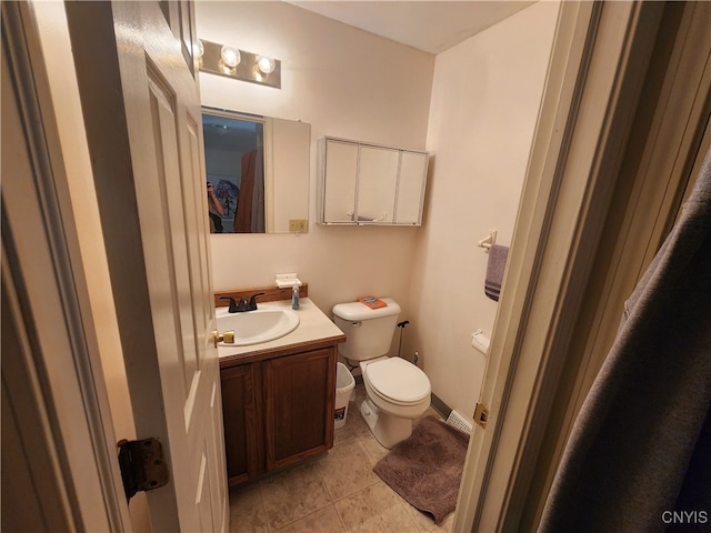 bathroom featuring vanity, toilet, and tile patterned floors