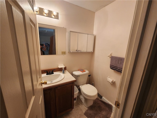 bathroom with vanity, toilet, and tile patterned floors