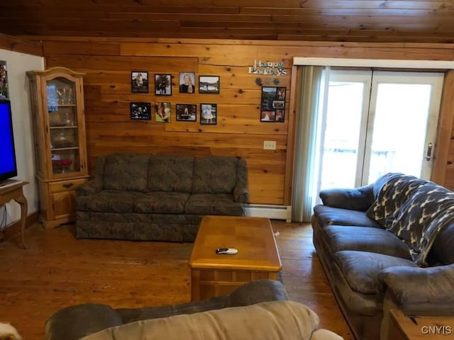 living room with a baseboard radiator, wooden walls, hardwood / wood-style floors, and wood ceiling