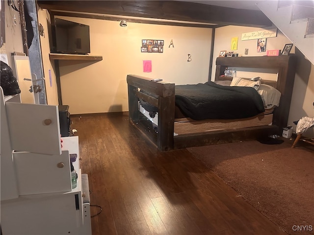 bedroom with dark hardwood / wood-style flooring