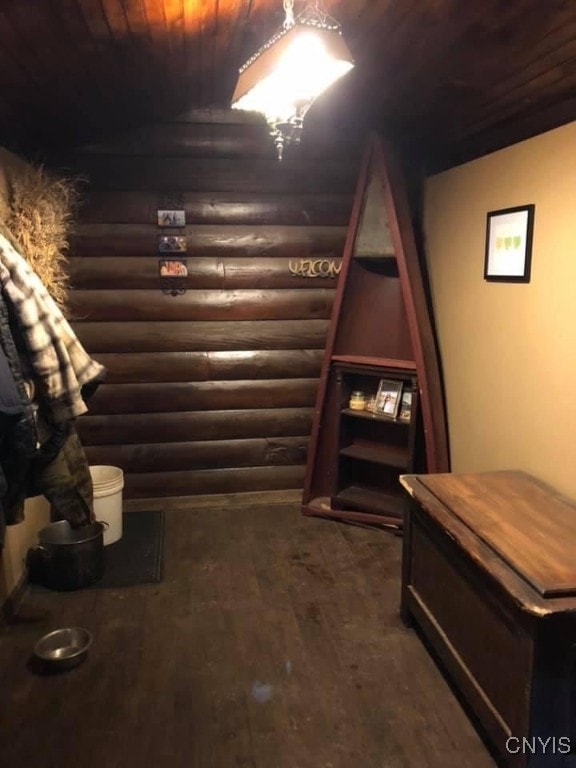 wine room featuring wood ceiling, rustic walls, and dark hardwood / wood-style floors