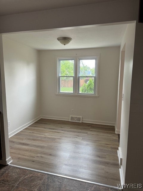 spare room featuring dark hardwood / wood-style flooring