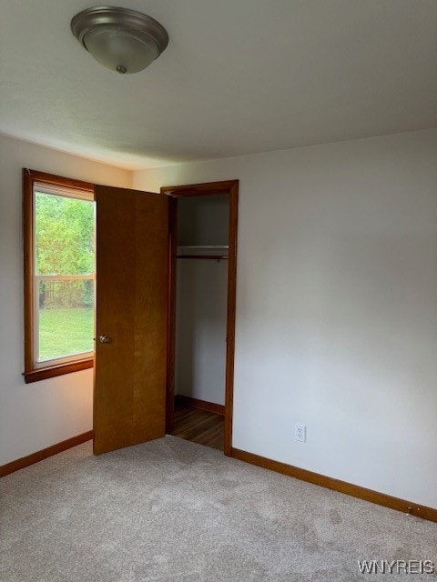 unfurnished bedroom featuring a closet and carpet flooring