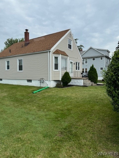 rear view of house with a lawn and a patio area