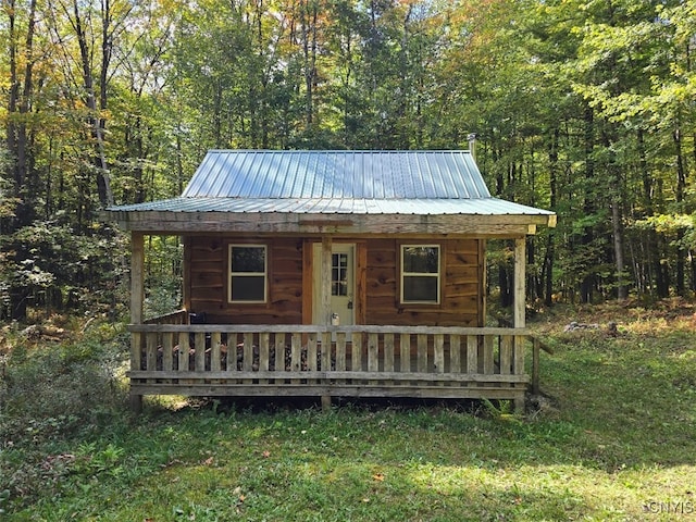 view of outdoor structure with a lawn and a porch