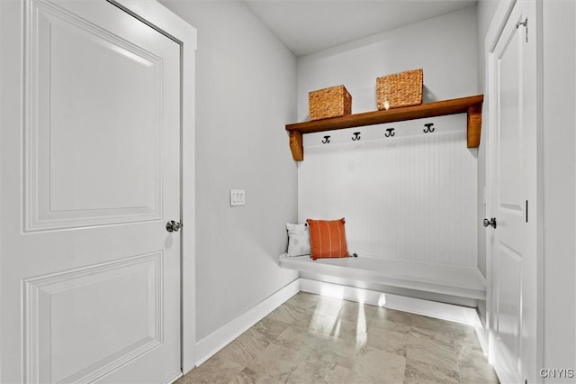 mudroom featuring marble finish floor and baseboards