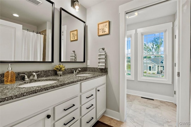 full bathroom featuring a sink, visible vents, and baseboards