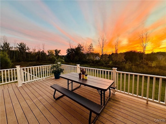 deck at dusk with a lawn