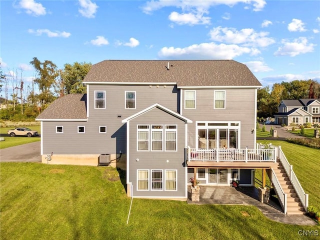 back of property with a yard, stairway, a patio area, a deck, and cooling unit