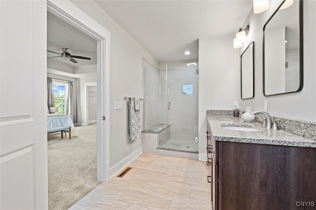 ensuite bathroom with a sink, baseboards, double vanity, a stall shower, and ensuite bath