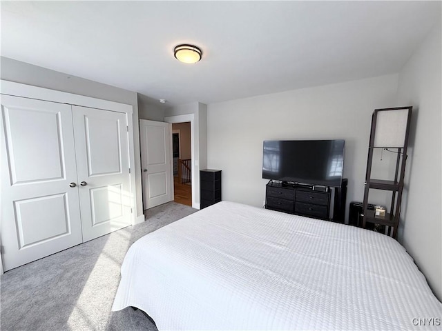 bedroom featuring a closet and light carpet