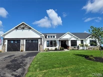 view of front of home featuring a garage and a front lawn