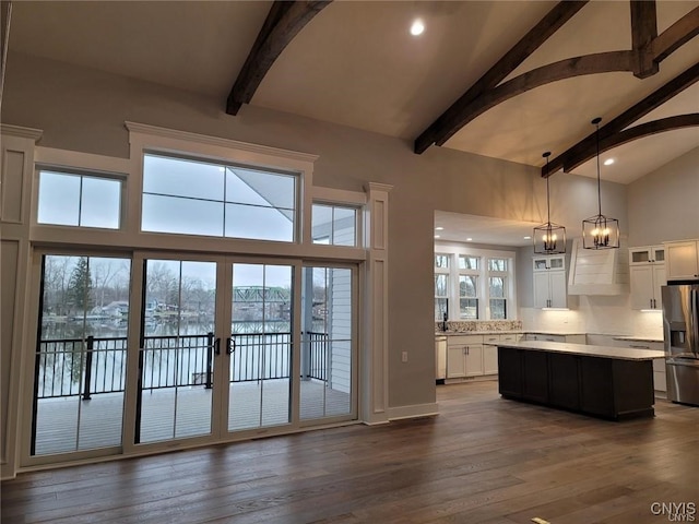 doorway to outside featuring beamed ceiling, sink, dark hardwood / wood-style flooring, and high vaulted ceiling