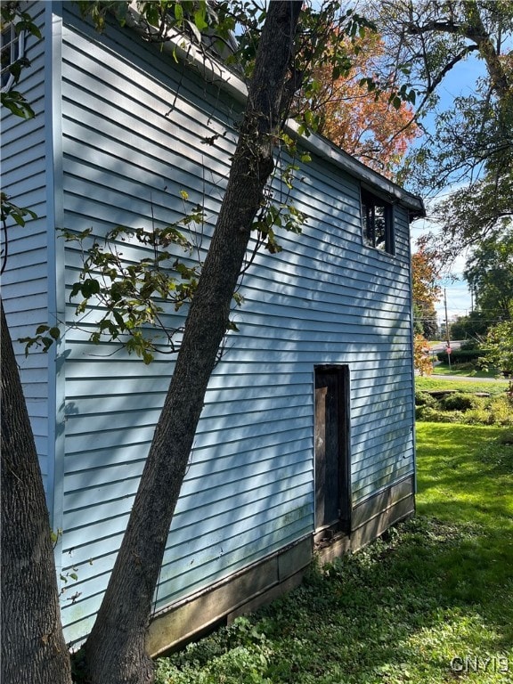 view of side of home featuring a yard