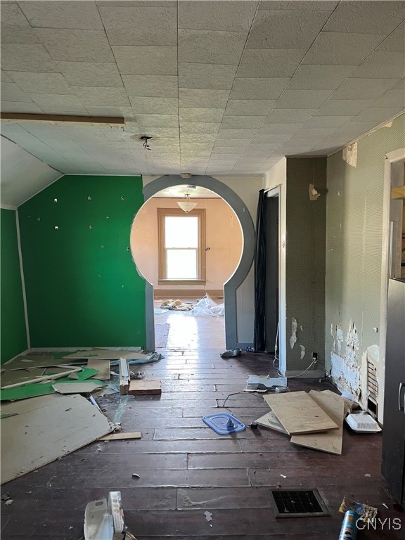 misc room featuring vaulted ceiling and hardwood / wood-style floors