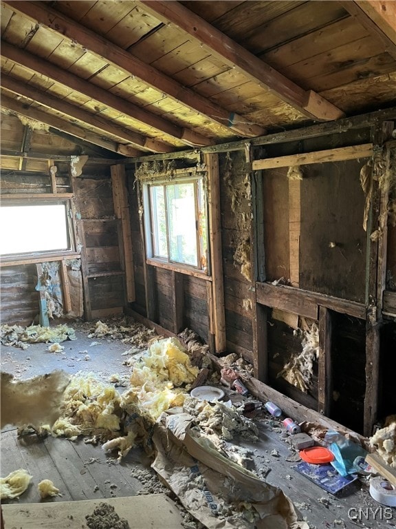 misc room with vaulted ceiling with beams, wooden ceiling, and a wealth of natural light