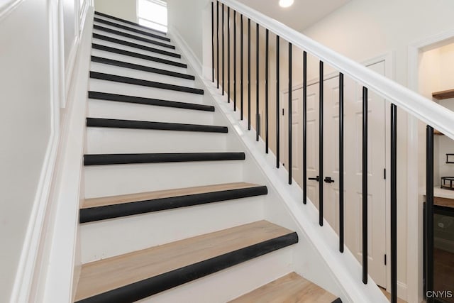 stairs featuring wood-type flooring