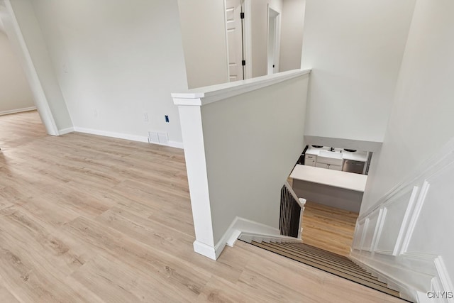 stairs featuring wood-type flooring