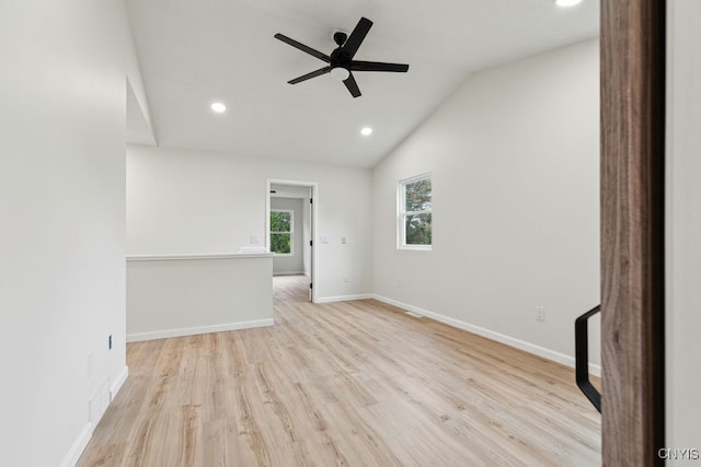 unfurnished room featuring vaulted ceiling, light hardwood / wood-style floors, and ceiling fan