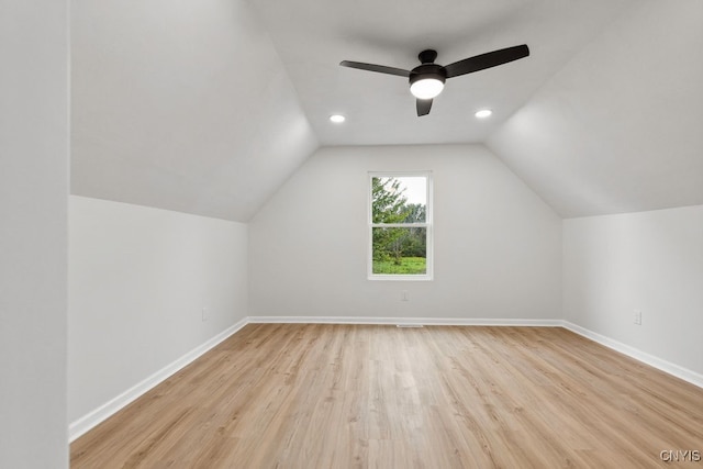 additional living space with ceiling fan, light hardwood / wood-style flooring, and vaulted ceiling