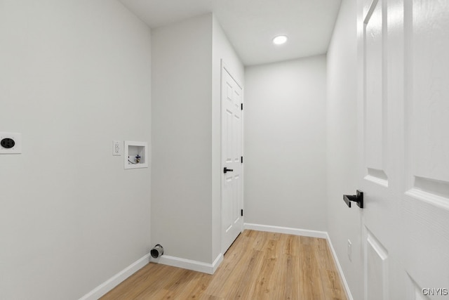 washroom featuring light hardwood / wood-style flooring, hookup for an electric dryer, and hookup for a washing machine