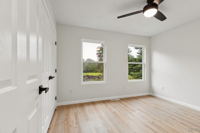 unfurnished room featuring light wood-type flooring and ceiling fan