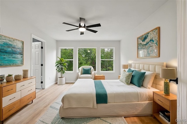 bedroom with ceiling fan and light hardwood / wood-style floors