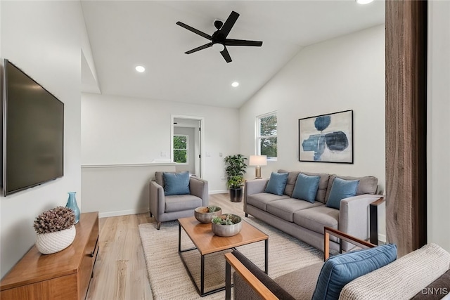 living room with light wood-type flooring, lofted ceiling, and ceiling fan