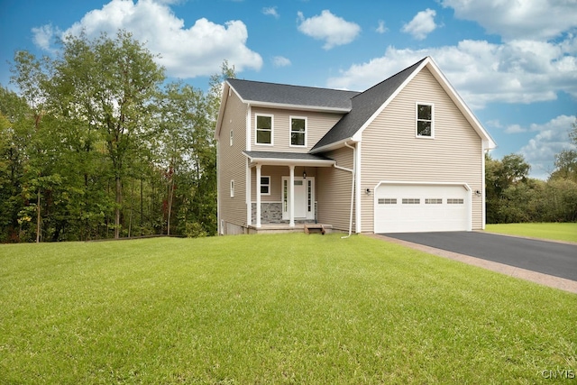 view of front of house featuring covered porch, a front yard, and a garage