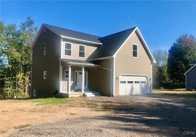 view of front property featuring covered porch and a garage