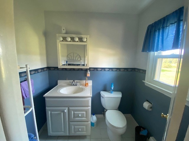 bathroom with vanity, tile patterned flooring, and toilet