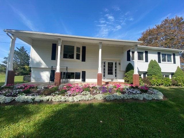 split foyer home with covered porch and a front yard