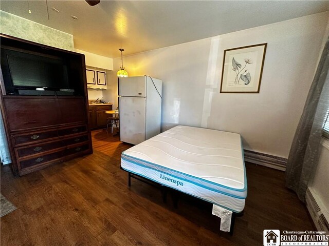 3682 Rte 430, Ellery, NY 14712 - bedroom featuring freestanding refrigerator, a baseboard radiator, and dark wood-style floors