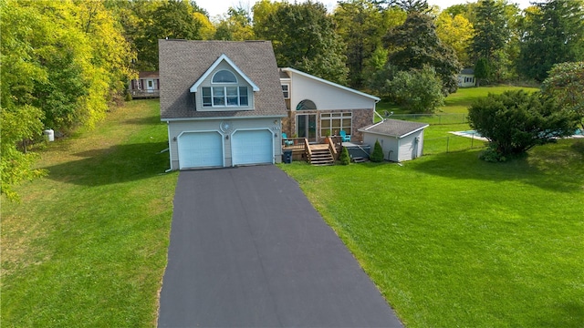 view of front of property featuring a garage and a front lawn