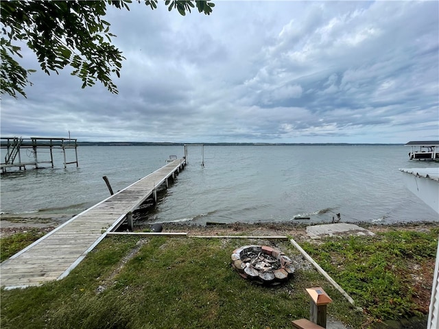 dock area featuring a water view and an outdoor fire pit