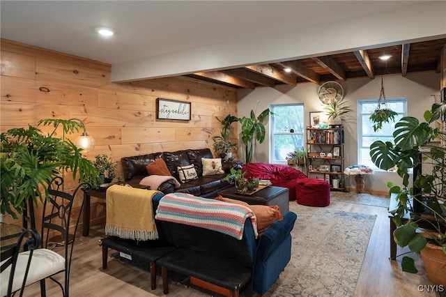 living room featuring wood-type flooring, beamed ceiling, and wooden walls