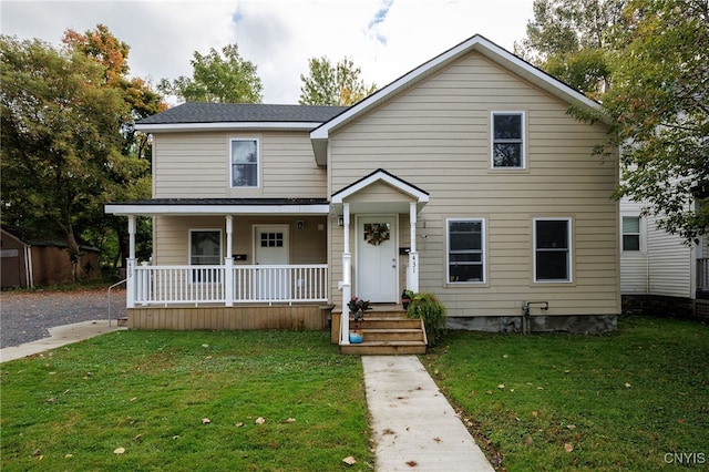 view of front of house with covered porch and a front yard