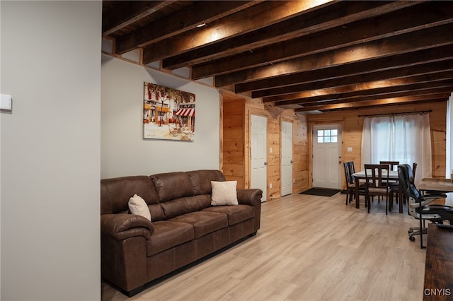 living room with beam ceiling and light hardwood / wood-style floors